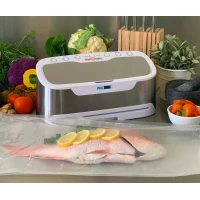 Grey and white vacuum sealer with vacuumed sealed fish